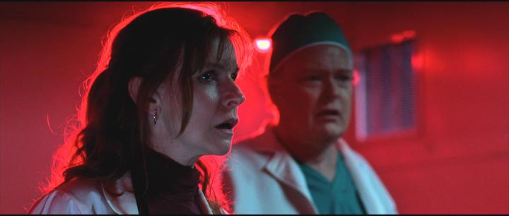 Christian Clemenson and Jacqueline McKenzie in Malignant (2021)