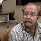 Wilford Brimley به عنوان Dr. Blair