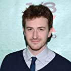 Joseph Mazzello به عنوان John Deacon