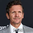 Sebastian Roché به عنوان Father Renaud