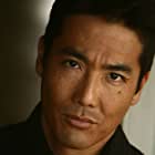 John Koyama به عنوان Omura's Bodyguard