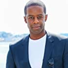 Adrian Lester به عنوان Conrad Grantchester