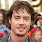 Jason London به عنوان John Zachary