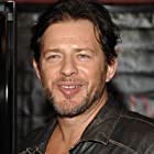 Costas Mandylor به عنوان Benjamin Poge