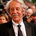 Jean Rochefort به عنوان Gilbert Neuville