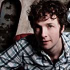 Chris Addison به عنوان Colin (Reporter)