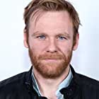 Brian Gleeson به عنوان Gus