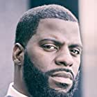 Rhymefest به عنوان Big George